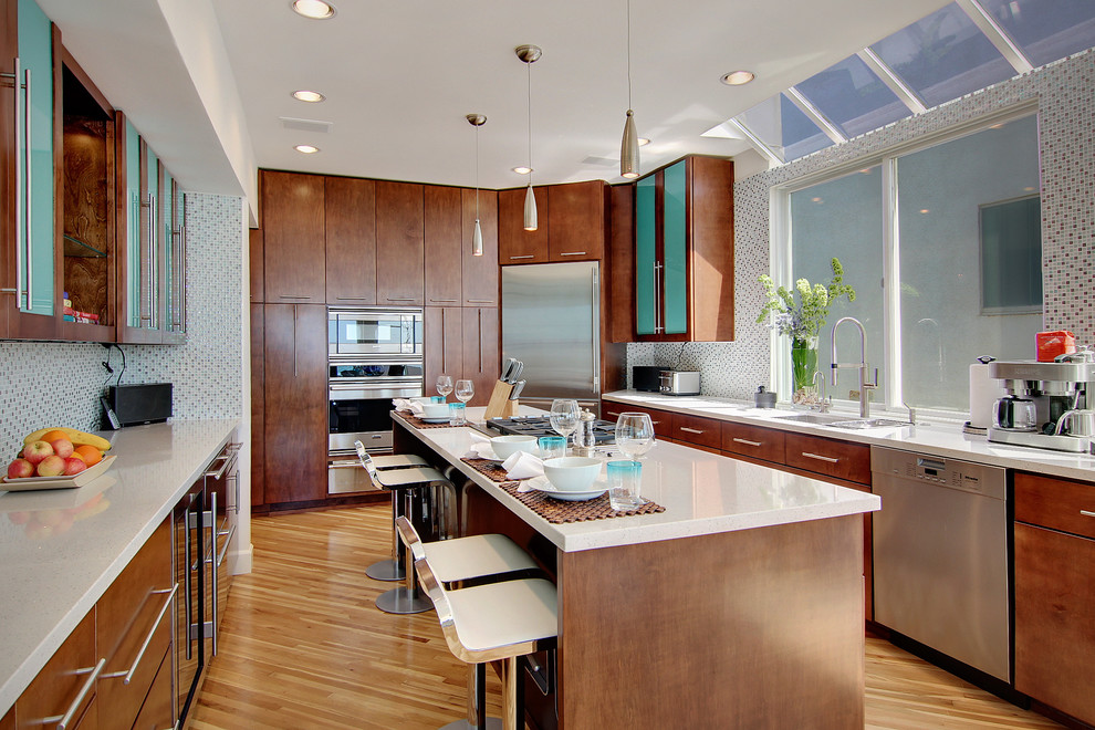 Inspiration for a contemporary kitchen remodel in Los Angeles with mosaic tile backsplash, stainless steel appliances, multicolored backsplash, flat-panel cabinets and dark wood cabinets