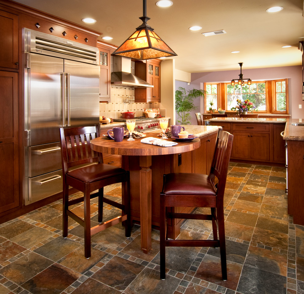 Example of a mid-sized arts and crafts l-shaped porcelain tile and multicolored floor eat-in kitchen design in Los Angeles with an undermount sink, shaker cabinets, granite countertops, metallic backsplash, mosaic tile backsplash, stainless steel appliances, two islands and medium tone wood cabinets