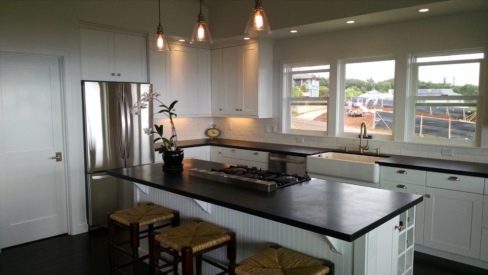 Moderne Küche mit Landhausspüle, Schrankfronten im Shaker-Stil, weißen Schränken, Rückwand aus Metrofliesen, Küchengeräten aus Edelstahl und Kücheninsel in Hawaii