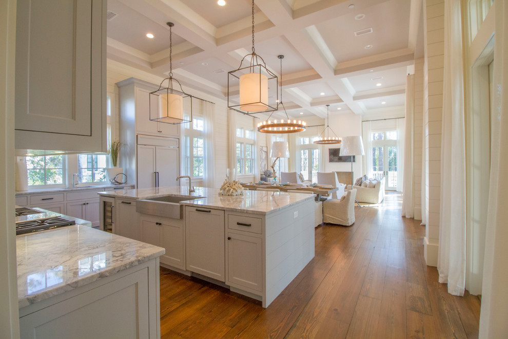 Beach style dark wood floor open concept kitchen photo in Miami with a farmhouse sink, shaker cabinets, white cabinets and an island