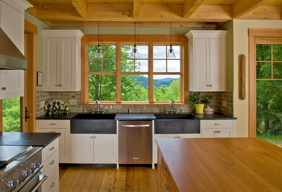 Open concept kitchen - large traditional medium tone wood floor open concept kitchen idea in Burlington with an integrated sink, shaker cabinets, beige cabinets, green backsplash, stainless steel appliances, wood countertops, mosaic tile backsplash and an island
