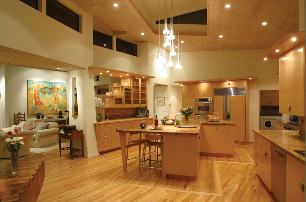 Foto på ett funkis kök med öppen planlösning, med släta luckor, skåp i mellenmörkt trä och integrerade vitvaror