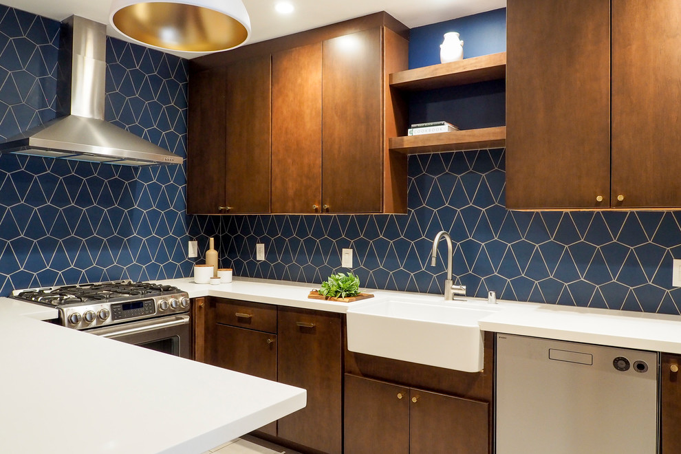 Inspiration for a small contemporary u-shaped ceramic tile and beige floor enclosed kitchen remodel in San Francisco with a farmhouse sink, flat-panel cabinets, dark wood cabinets, blue backsplash, ceramic backsplash, stainless steel appliances, a peninsula and white countertops