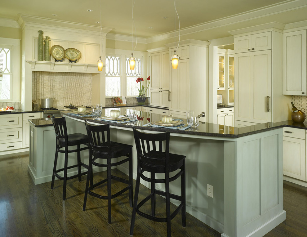 Elegant kitchen photo in Atlanta with shaker cabinets, beige cabinets and beige backsplash