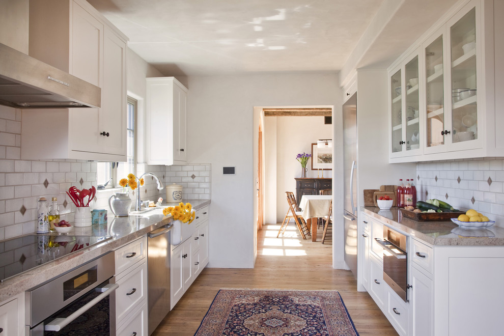 Klassische Küche mit Glasfronten, Küchengeräten aus Edelstahl und Landhausspüle in Santa Barbara