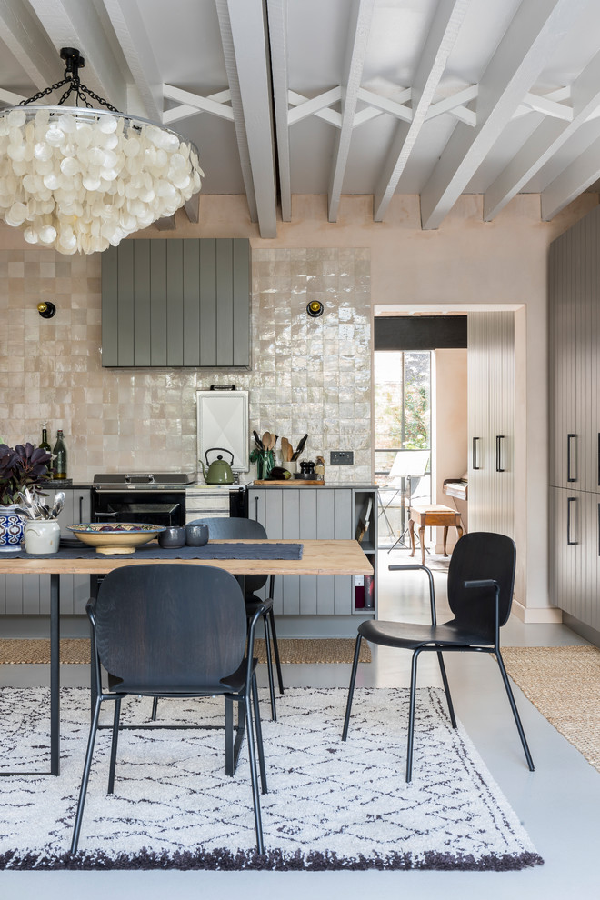 Inspiration for an industrial grey and cream kitchen/diner in London with grey cabinets, limestone worktops, concrete flooring and grey floors.