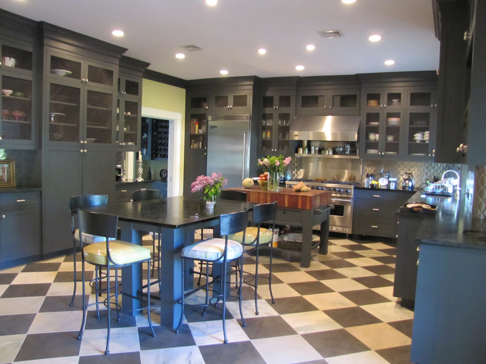 Huge elegant u-shaped ceramic tile eat-in kitchen photo in New York with a single-bowl sink, recessed-panel cabinets, gray cabinets, soapstone countertops, stainless steel appliances and two islands