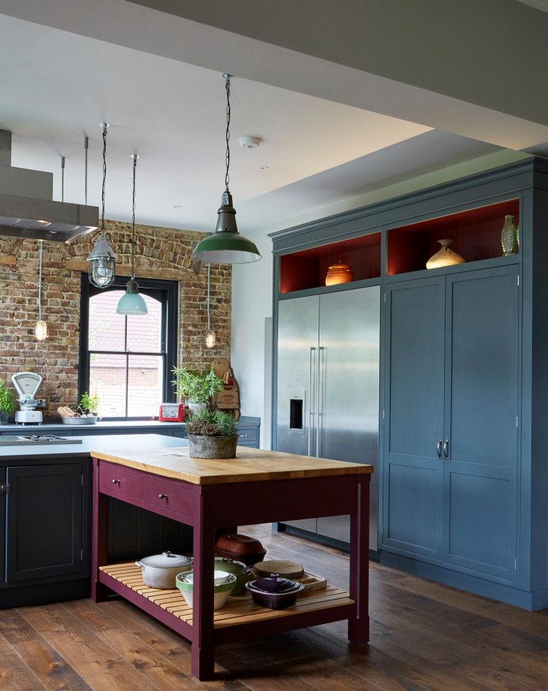 Inspiration for a huge eclectic kitchen remodel in London with pink cabinets, wood countertops, shaker cabinets, stainless steel appliances and two islands