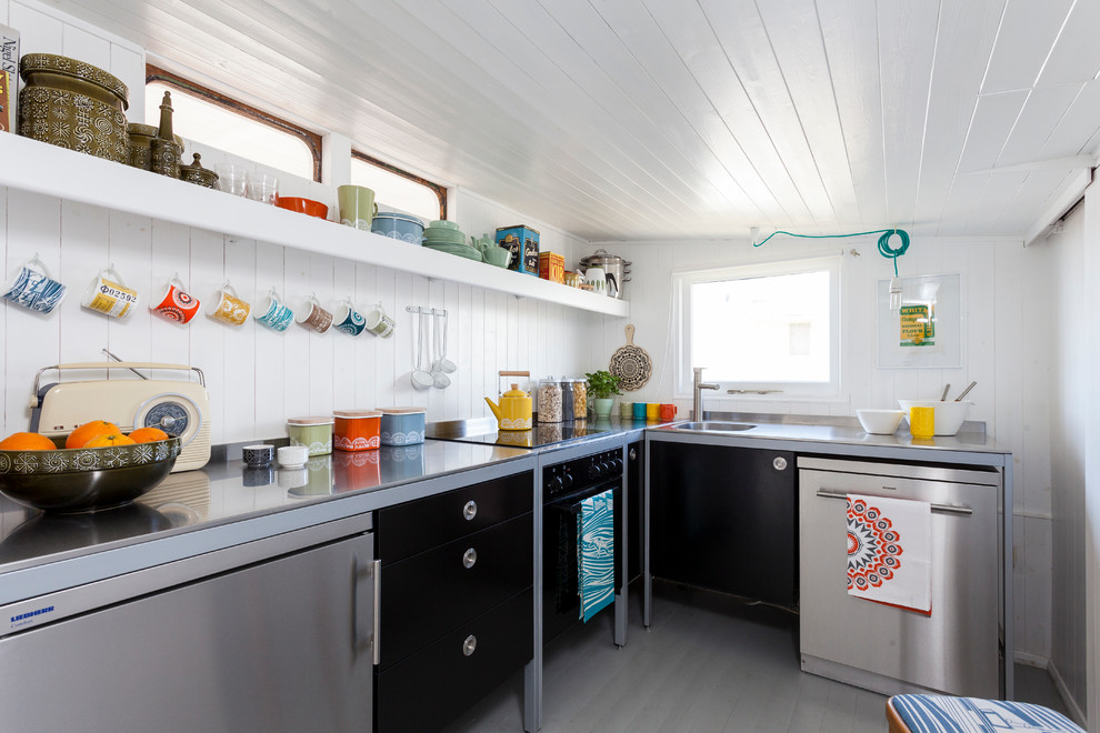 Design ideas for a small scandi l-shaped kitchen in London with flat-panel cabinets, black cabinets and stainless steel appliances.