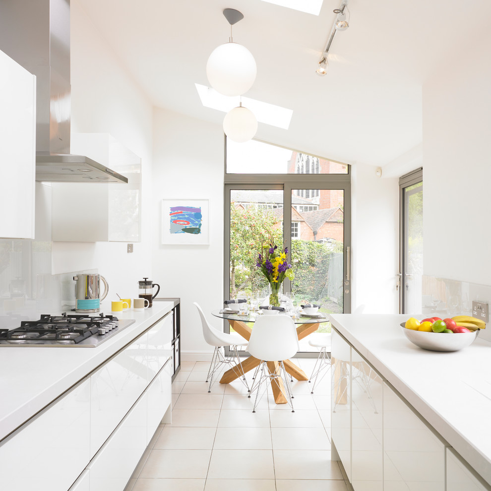 Inspiration for a contemporary kitchen in West Midlands with a double-bowl sink, glass sheet splashback and stainless steel appliances.