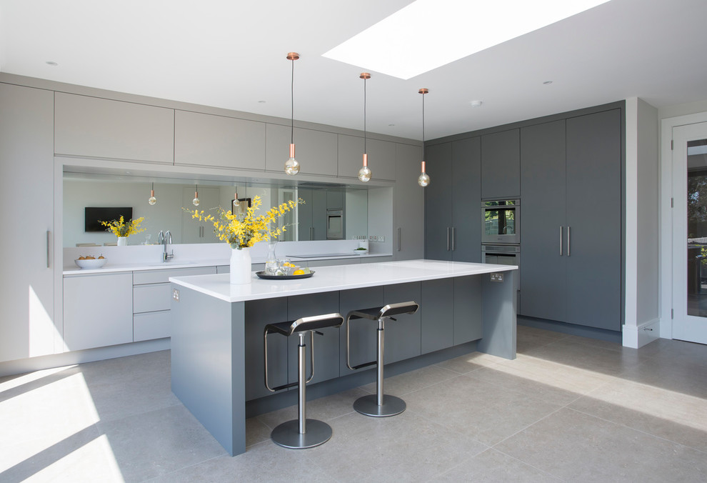 Medium sized contemporary kitchen in Other with flat-panel cabinets, grey cabinets, mirror splashback, an island, a submerged sink, grey floors and porcelain flooring.