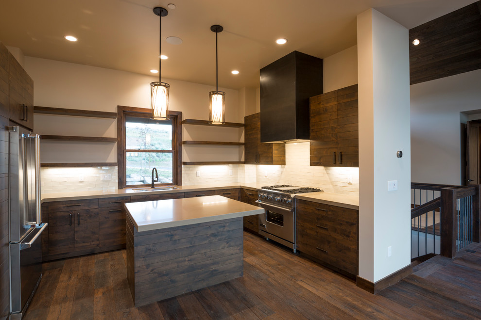 Inspiration for a mid-sized rustic u-shaped dark wood floor open concept kitchen remodel in Salt Lake City with white backsplash, stainless steel appliances, an island, an undermount sink, flat-panel cabinets, dark wood cabinets, solid surface countertops and subway tile backsplash