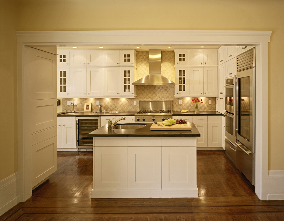 Example of a small classic galley medium tone wood floor and brown floor eat-in kitchen design in San Francisco with a single-bowl sink, shaker cabinets, light wood cabinets, granite countertops, multicolored backsplash, mosaic tile backsplash, stainless steel appliances and an island