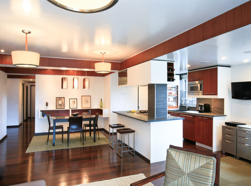 Offene Moderne Küche mit flächenbündigen Schrankfronten, dunklen Holzschränken, Küchenrückwand in Grau, Rückwand aus Steinfliesen und Küchengeräten aus Edelstahl in New York
