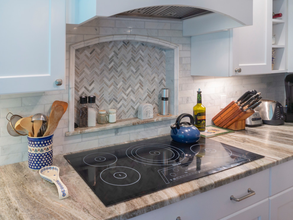 View of the Cooktop Area with archtop niche and wood hood
