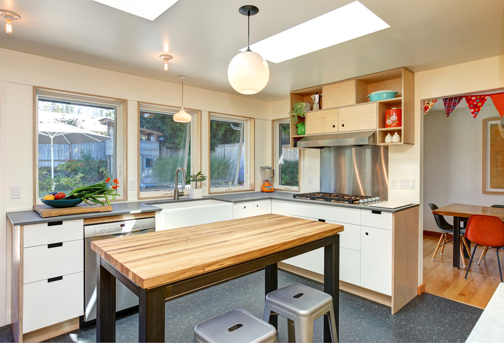 Enclosed kitchen - contemporary linoleum floor enclosed kitchen idea in Seattle with a farmhouse sink, flat-panel cabinets, white cabinets, metal backsplash, stainless steel appliances, an island and metallic backsplash