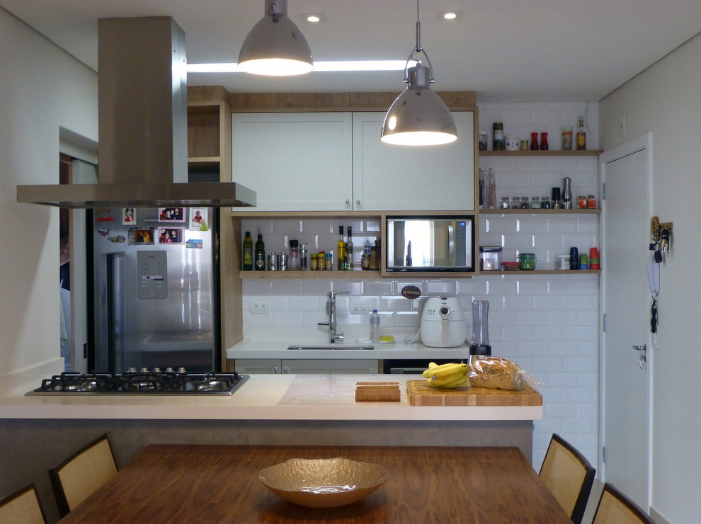 Photo of a medium sized contemporary kitchen/diner in Other with a single-bowl sink, grey cabinets, quartz worktops, white splashback, porcelain splashback, stainless steel appliances, porcelain flooring and an island.