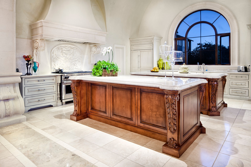 Tuscan l-shaped kitchen photo in Austin with raised-panel cabinets, gray cabinets, beige backsplash and stainless steel appliances