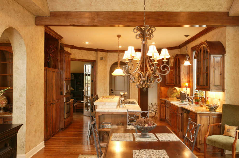 Example of a large classic galley light wood floor eat-in kitchen design in Kansas City with a double-bowl sink, raised-panel cabinets, light wood cabinets, marble countertops, beige backsplash, ceramic backsplash, stainless steel appliances and an island