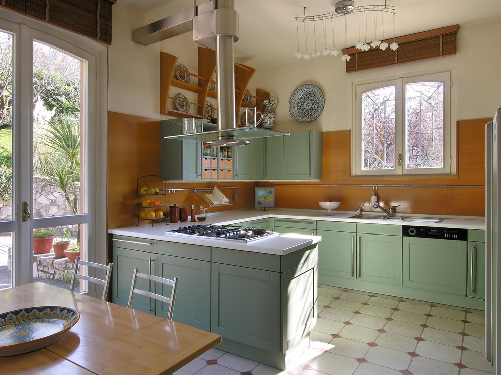 Example of a large farmhouse u-shaped enclosed kitchen design in Rome with a drop-in sink, shaker cabinets, green cabinets, paneled appliances and solid surface countertops