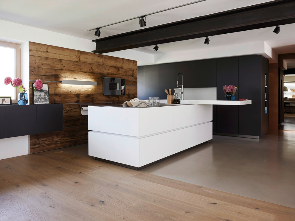 Inspiration for a large contemporary open plan kitchen in New York with flat-panel cabinets and an island.