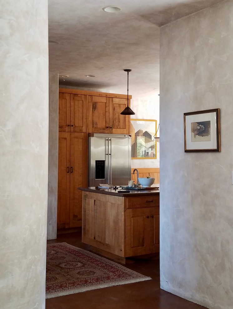 Idéer för mellanstora medelhavsstil kök, med en dubbel diskho, luckor med upphöjd panel, skåp i mellenmörkt trä, bänkskiva i koppar, brunt stänkskydd, rostfria vitvaror, en köksö, brunt golv och betonggolv