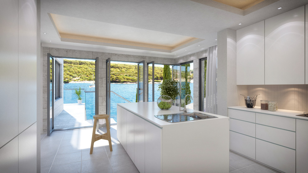 Cette image montre une cuisine ouverte design en U avec des portes de placard blanches, un plan de travail en surface solide et un sol en carrelage de porcelaine.