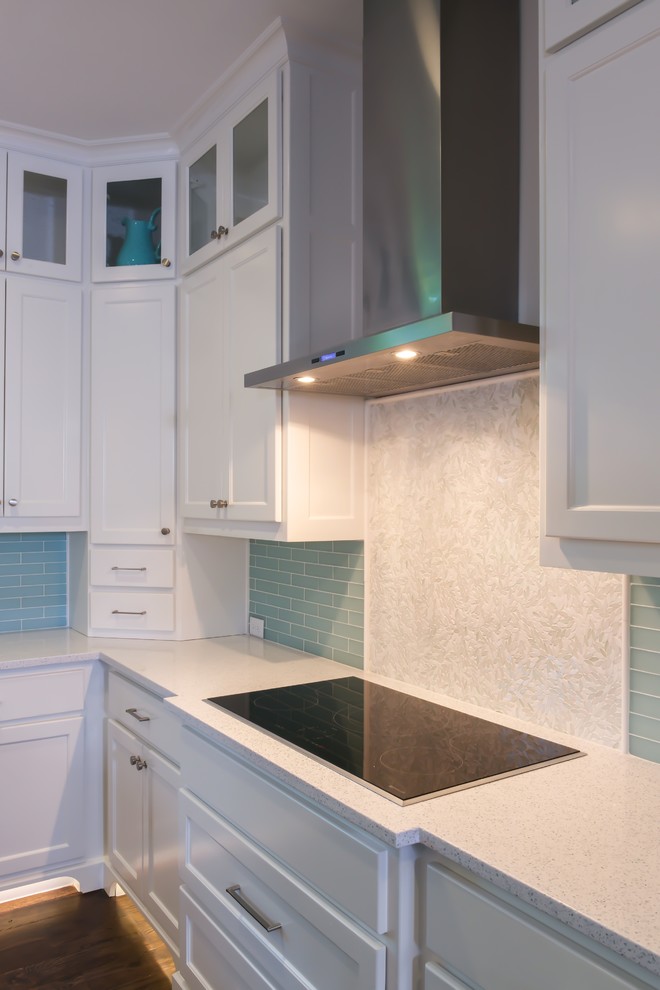 Inspiration for a large contemporary l-shaped open plan kitchen in Dallas with a belfast sink, shaker cabinets, white cabinets, recycled glass countertops, blue splashback, glass tiled splashback, stainless steel appliances, dark hardwood flooring and multiple islands.