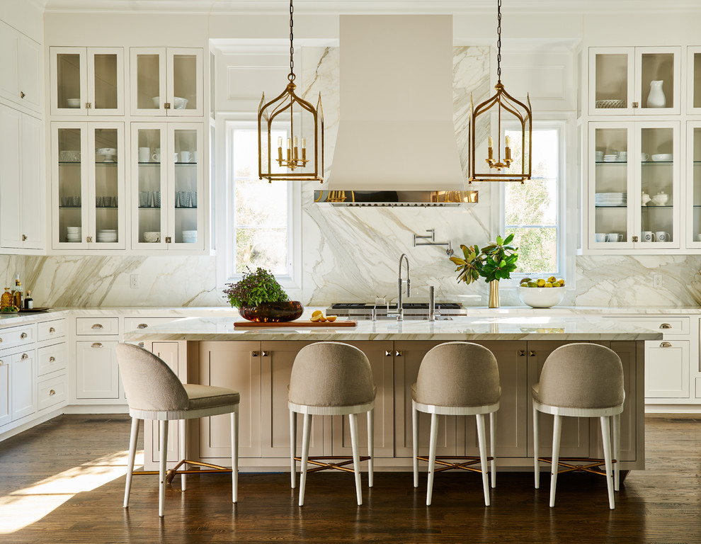 Inspiration for a traditional kitchen in Dallas with glass-front cabinets, white cabinets, white splashback, dark hardwood flooring, an island and brown floors.