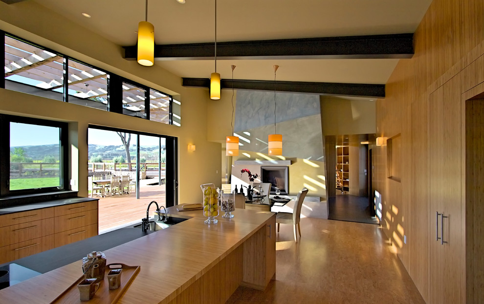 Example of a large classic u-shaped cork floor and beige floor eat-in kitchen design in San Francisco with an undermount sink, flat-panel cabinets, medium tone wood cabinets, multicolored backsplash, stainless steel appliances, an island, solid surface countertops and stone slab backsplash