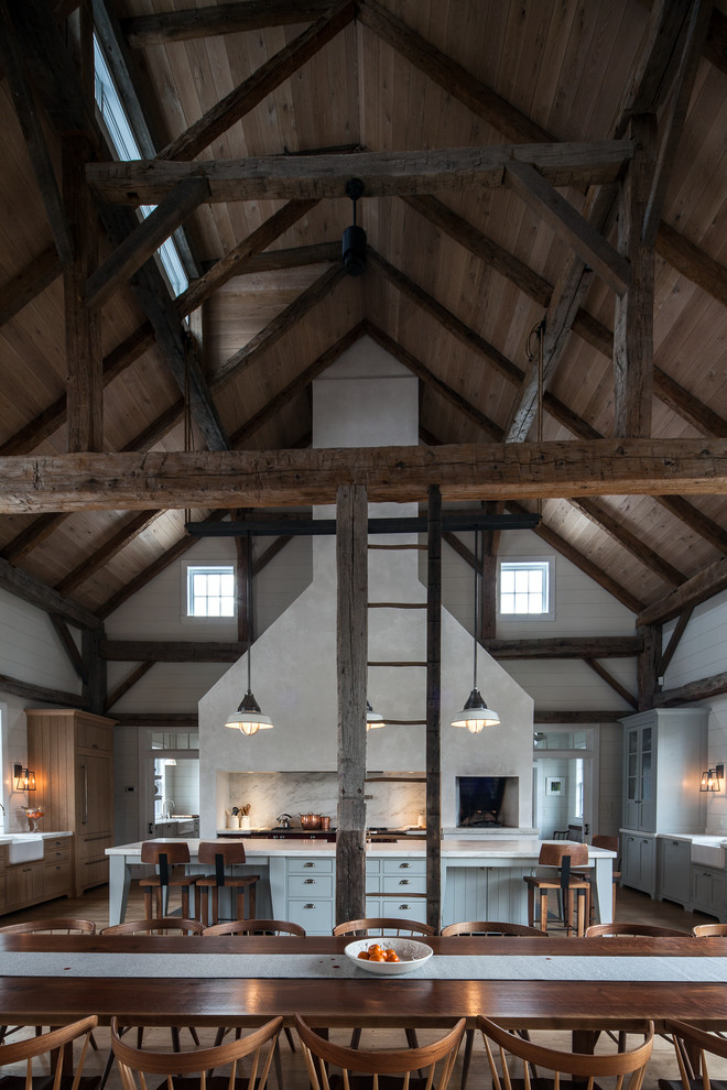 Example of a mountain style eat-in kitchen design in Boston with a farmhouse sink, marble countertops, white backsplash and stone slab backsplash
