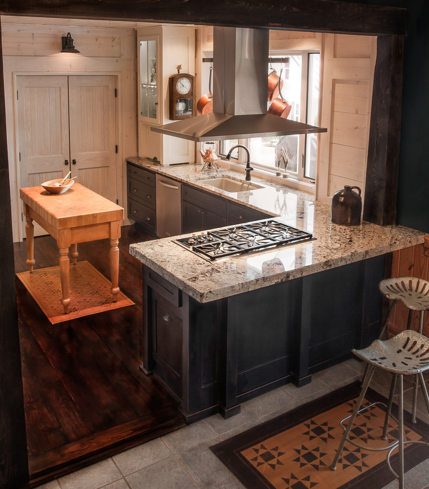 Example of a small cottage l-shaped dark wood floor enclosed kitchen design in Atlanta with an undermount sink, shaker cabinets, distressed cabinets, granite countertops, stainless steel appliances and an island