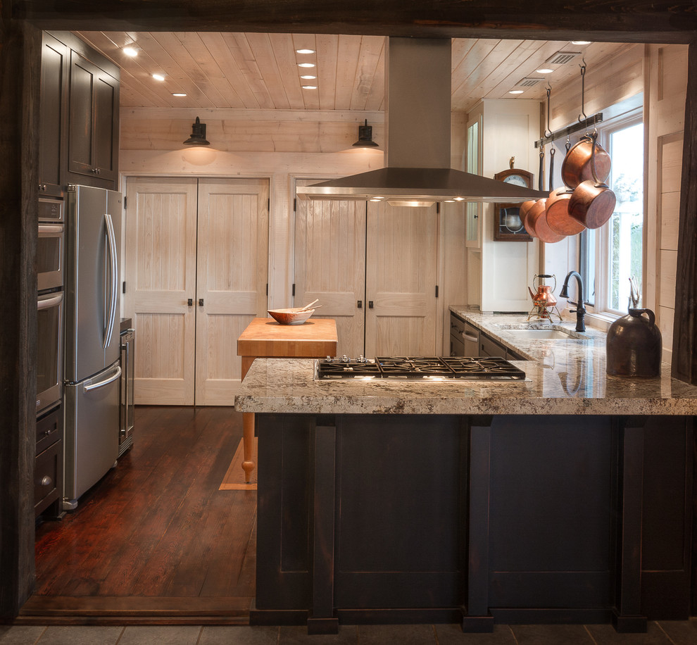 Kitchen - mid-sized cottage l-shaped dark wood floor and brown floor kitchen idea in Atlanta with shaker cabinets, dark wood cabinets, granite countertops, stainless steel appliances and a peninsula