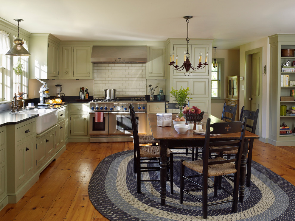 Inspiration for a farmhouse l-shaped eat-in kitchen remodel in New York with a farmhouse sink, recessed-panel cabinets and stainless steel appliances