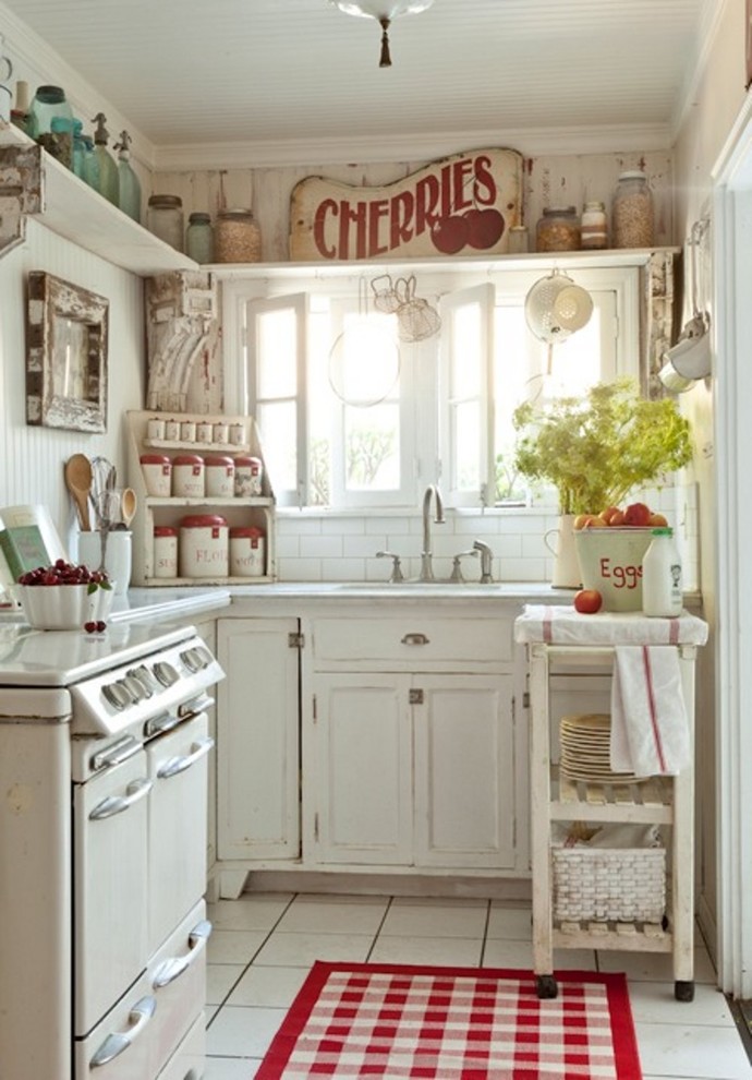 Enclosed kitchen - shabby-chic style enclosed kitchen idea in Los Angeles with distressed cabinets, white backsplash, subway tile backsplash and white appliances