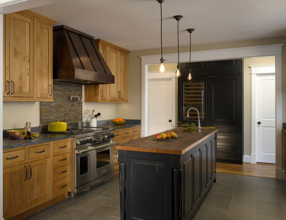 Example of a classic kitchen design in DC Metro with shaker cabinets, distressed cabinets, soapstone countertops, stone tile backsplash and paneled appliances