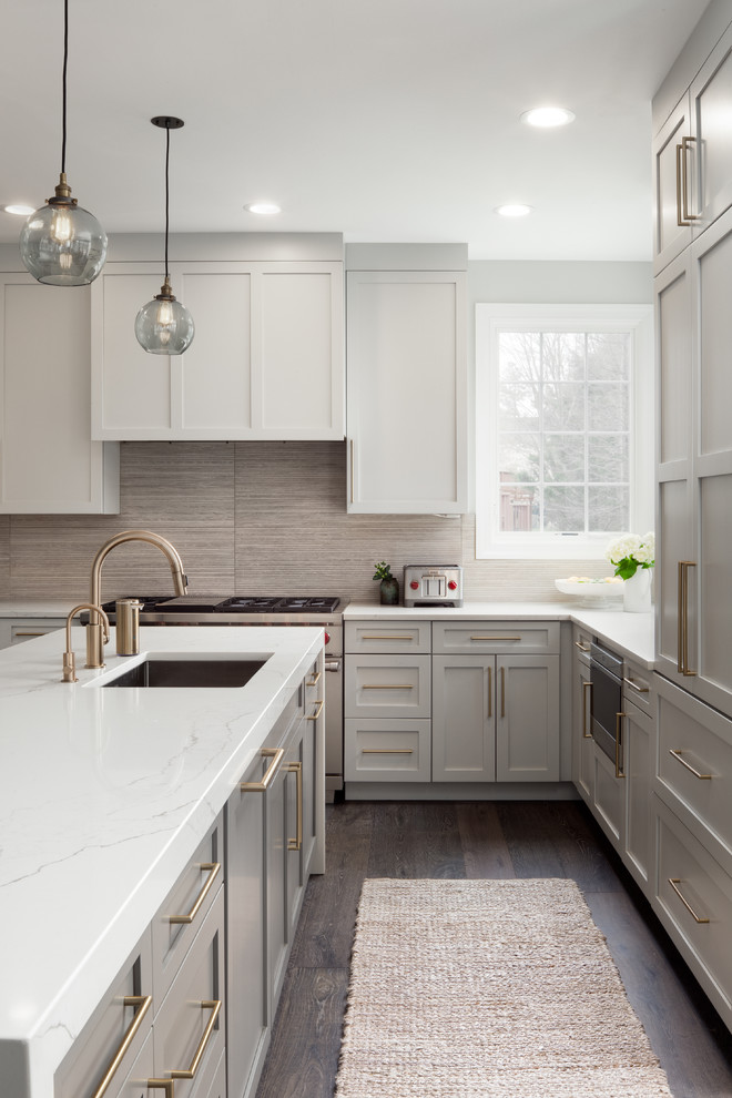 Inspiration for a large classic u-shaped kitchen in DC Metro with shaker cabinets, grey cabinets, engineered stone countertops, integrated appliances and white worktops.