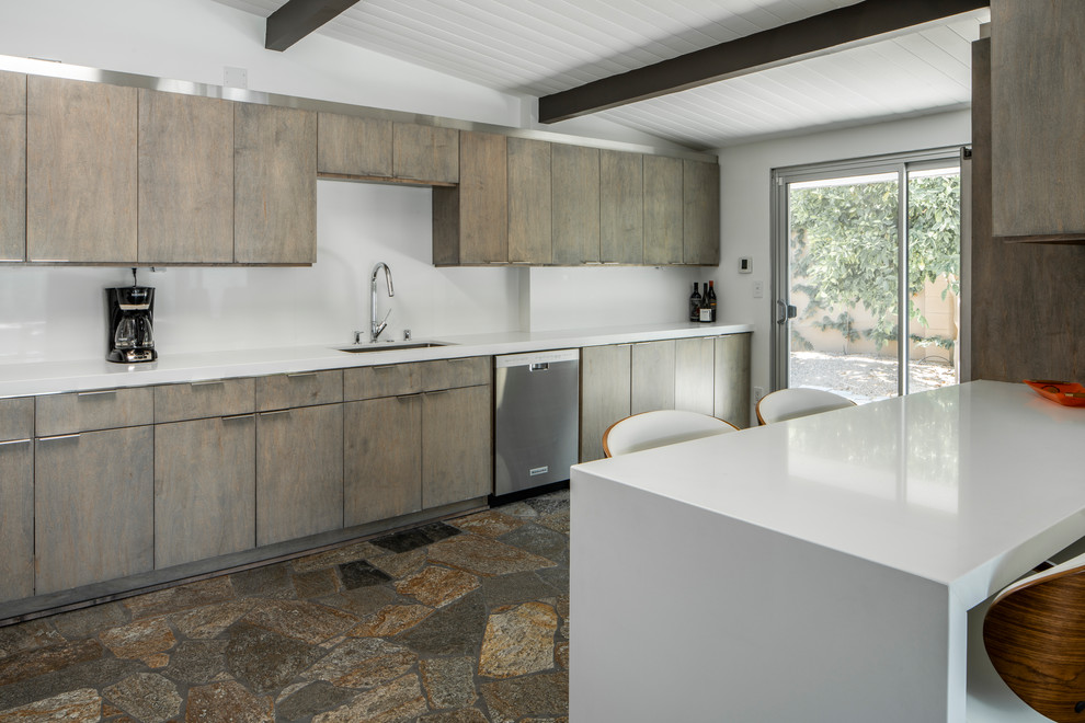Example of a large mid-century modern l-shaped slate floor and multicolored floor open concept kitchen design in Other with an undermount sink, flat-panel cabinets, distressed cabinets, quartz countertops, white backsplash, stone slab backsplash, stainless steel appliances, a peninsula and white countertops