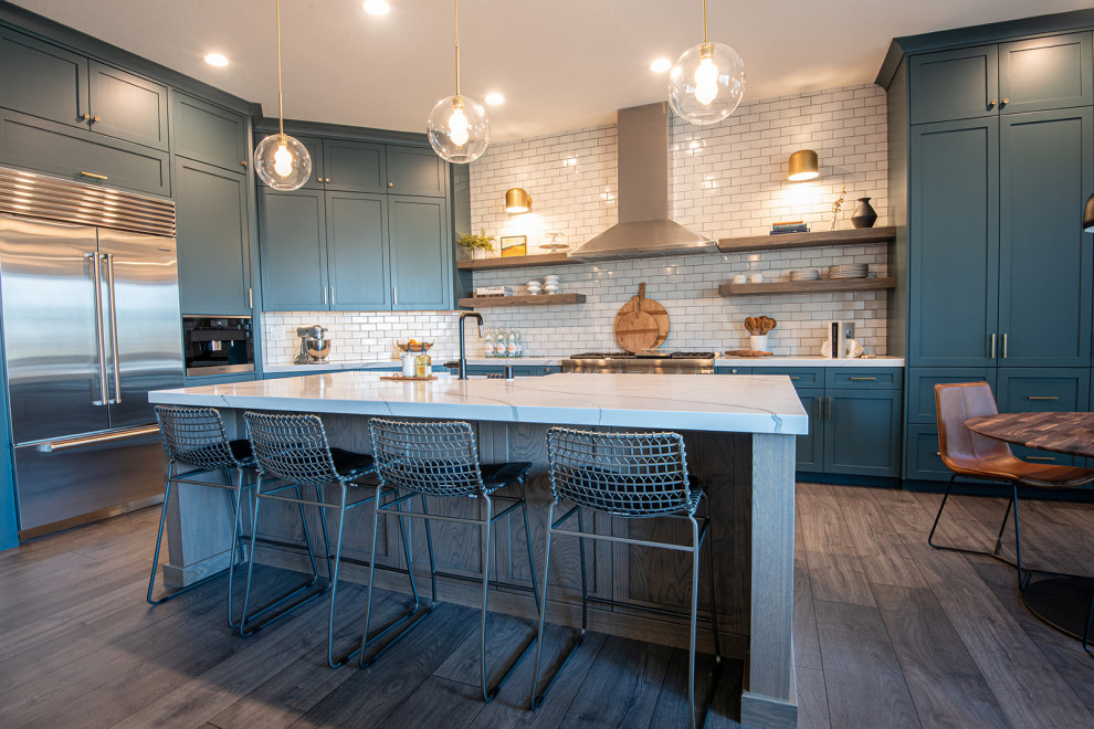 Inspiration for a large transitional laminate floor and brown floor open concept kitchen remodel in Sacramento with a farmhouse sink, shaker cabinets, turquoise cabinets, quartz countertops, white backsplash, ceramic backsplash, stainless steel appliances, an island and white countertops