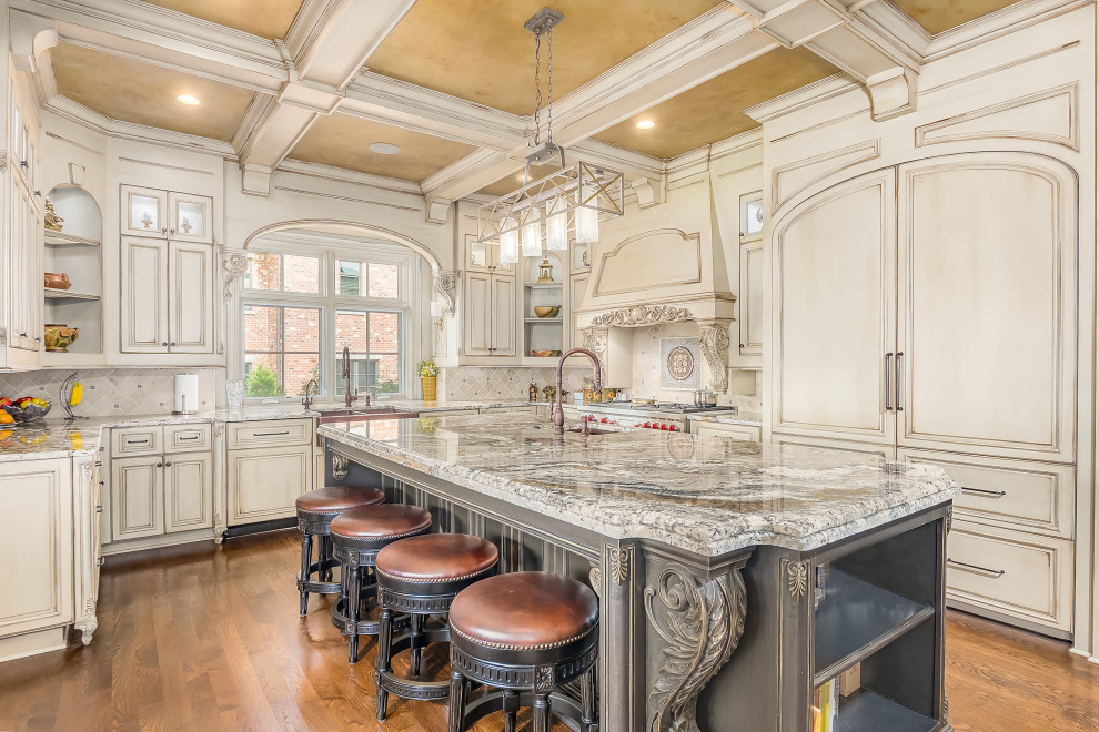 Inspiration for an u-shaped kitchen in Detroit with a belfast sink, raised-panel cabinets, beige cabinets, integrated appliances, dark hardwood flooring, an island, brown floors, grey worktops and a coffered ceiling.