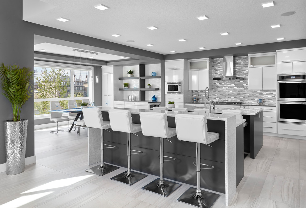 Eat-in kitchen - large contemporary galley porcelain tile and gray floor eat-in kitchen idea in Edmonton with an undermount sink, louvered cabinets, white cabinets, quartz countertops, multicolored backsplash, subway tile backsplash, stainless steel appliances, two islands and white countertops