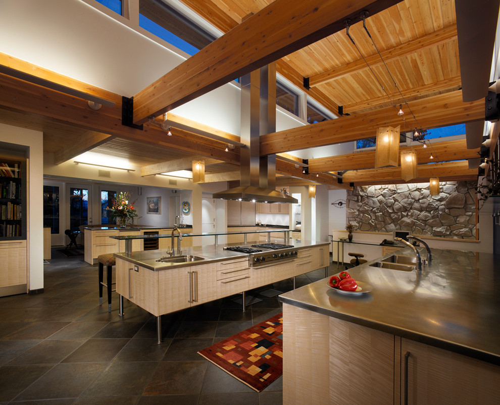 Contemporary kitchen in Denver with stainless steel worktops, an integrated sink, flat-panel cabinets, light wood cabinets and stainless steel appliances.