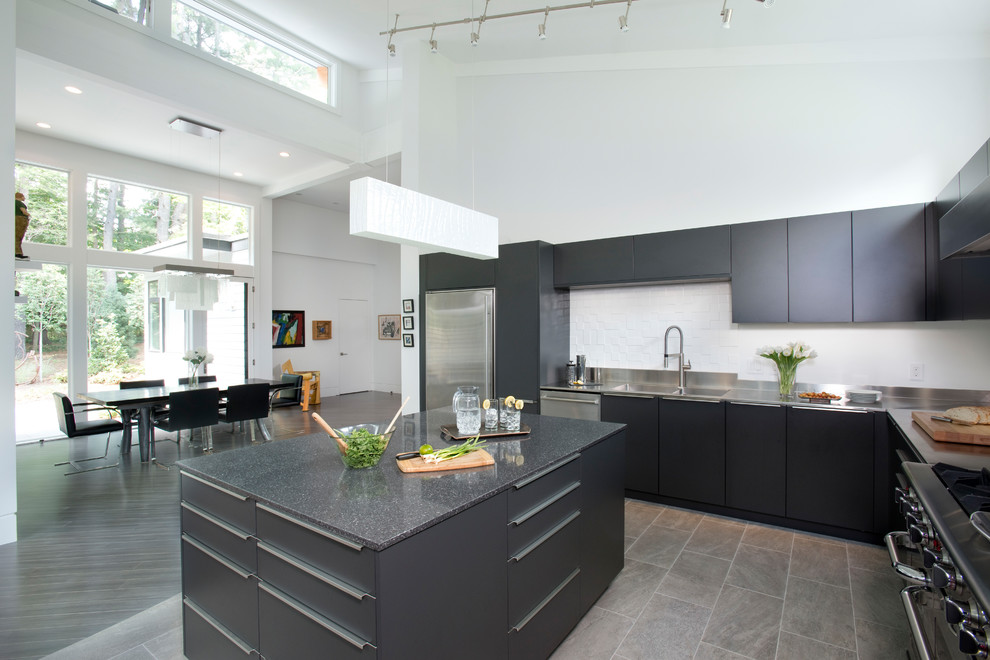 This is an example of a large modern u-shaped open plan kitchen in Boston with a double-bowl sink, flat-panel cabinets, dark wood cabinets, stainless steel worktops, stainless steel appliances, ceramic flooring, an island, beige floors and grey worktops.