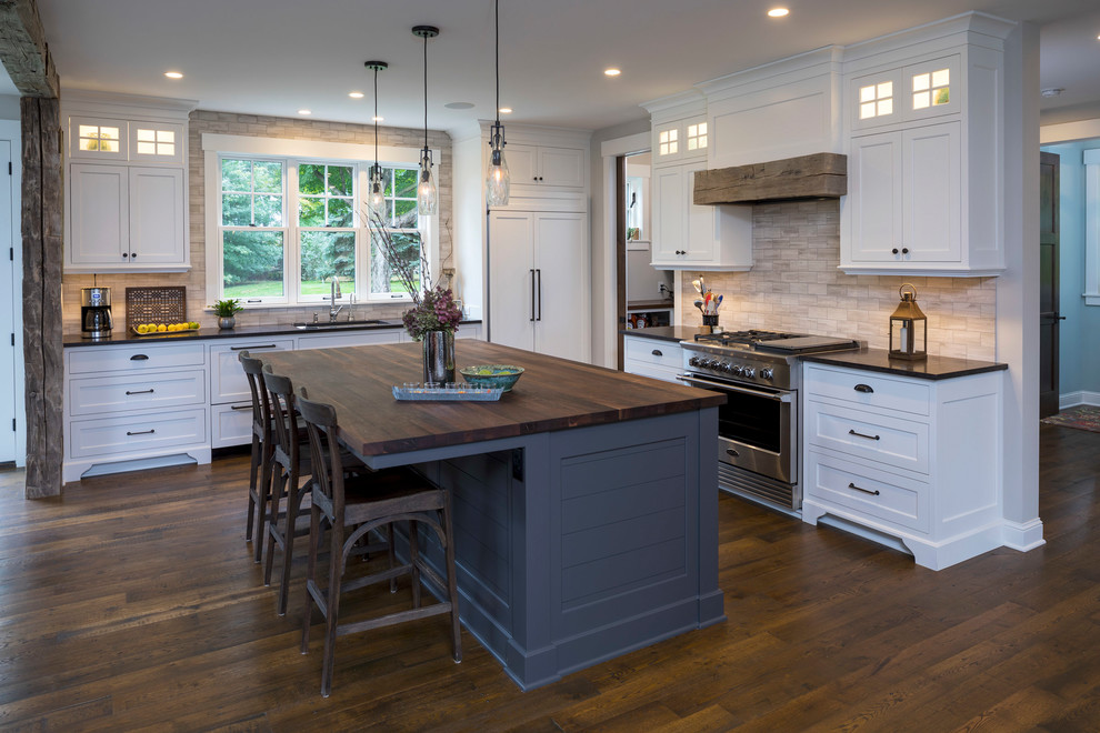 Photo of a medium sized nautical l-shaped kitchen in Minneapolis with a submerged sink, flat-panel cabinets, white cabinets, granite worktops, ceramic splashback, integrated appliances, dark hardwood flooring, an island and brown floors.