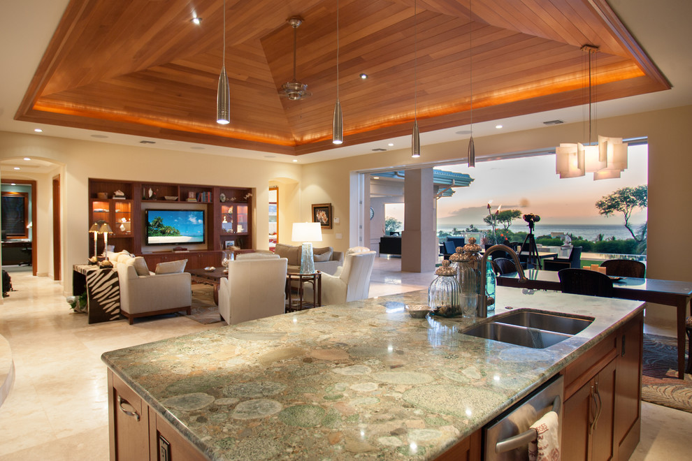 Example of a mid-sized island style l-shaped ceramic tile and beige floor open concept kitchen design in Hawaii with granite countertops, an island, a double-bowl sink, glass-front cabinets, medium tone wood cabinets, white backsplash, porcelain backsplash and stainless steel appliances
