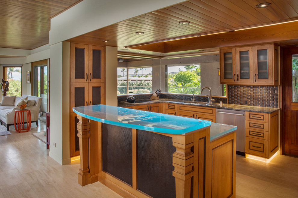 Large beach style l-shaped light wood floor and brown floor open concept kitchen photo in Hawaii with a drop-in sink, glass-front cabinets, medium tone wood cabinets, glass countertops, brown backsplash, wood backsplash, stainless steel appliances, an island and turquoise countertops