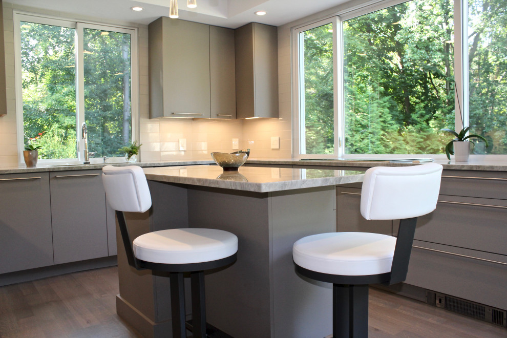 Example of a mid-sized trendy u-shaped light wood floor and gray floor eat-in kitchen design in Boston with an undermount sink, flat-panel cabinets, gray cabinets, quartzite countertops, beige backsplash, porcelain backsplash, stainless steel appliances, an island and gray countertops
