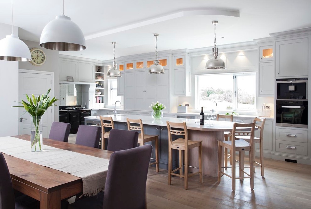 Inspiration for a traditional l-shaped kitchen/diner in Dublin with shaker cabinets, grey cabinets and black appliances.