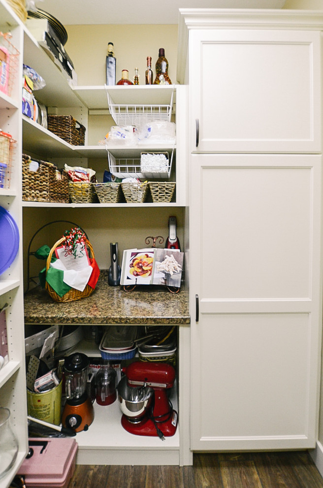 Photo of a medium sized l-shaped kitchen pantry in Other with medium hardwood flooring, brown floors, multicoloured worktops, open cabinets and white cabinets.