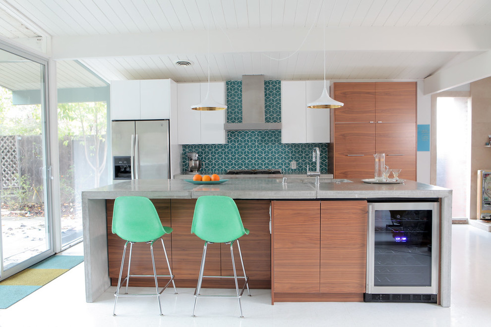 Inspiration for a mid-century modern galley vinyl floor eat-in kitchen remodel in San Francisco with an undermount sink, flat-panel cabinets, medium tone wood cabinets, concrete countertops, blue backsplash, ceramic backsplash, stainless steel appliances and an island